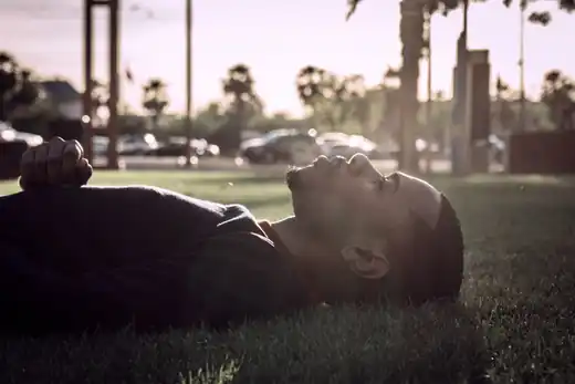 Man reclining on grass in soft afternoon light